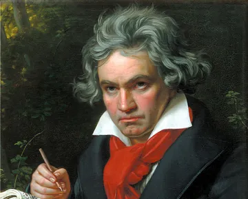 Pintura de Beethoven, homem branco com cabelos brancos. Ele veste uma camisa branca, com uma exarpe veremlha amarrada no pescoço e uma casaca preta sobre os ombros. Segura um lápis e uma partitura, como se estivesse compondo.